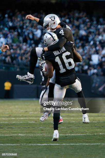Johnny Holton of the Oakland Raiders celebrates with teammate Derek Carr after scoring a touchdown against the New York Giants at Oakland-Alameda...