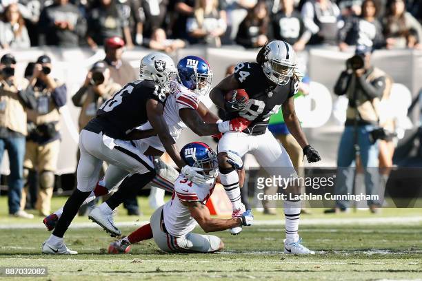 Cordarrelle Patterson of the Oakland Raiders is tackled by Dominique Rodgers-Cromartie and Ross Cockrell of the New York Giants at Oakland-Alameda...