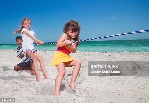 young kids playing tug-of-war - captiva island stock-fotos und bilder