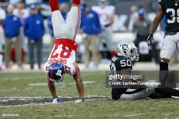 Sterling Shepard of the New York Giants gets to his feet with a handstand after a play with Nicholas Morrow of the Oakland Raiders at Oakland-Alameda...