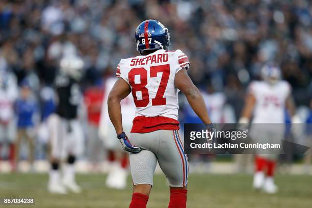 Sterling Shepard of the New York Giants grabs at his leg during the game against the Oakland Raiders at Oakland-Alameda County Coliseum on December...
