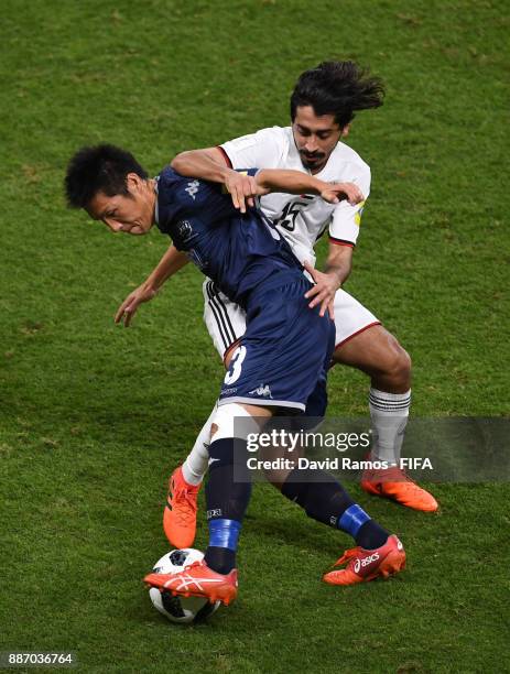 Takuya Iwata of Auckland City FC is challenged by Khalfan Alrezzi of Al-Jazira during the FIFA Club World Cup UAE 2017 play off match between Al...