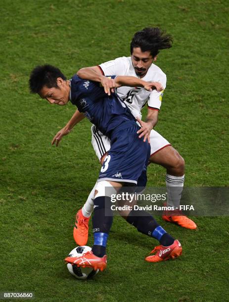 Takuya Iwata of Auckland City FC is challenged by Khalfan Alrezzi of Al-Jazira during the FIFA Club World Cup UAE 2017 play off match between Al...