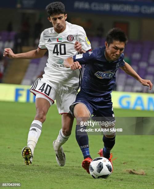 Auckland City's Takuya Iwata fights for the ball against UAE's al-Jazira club player Mohamad al-Attas during their FIFA Club World Cup UAE 2017 first...