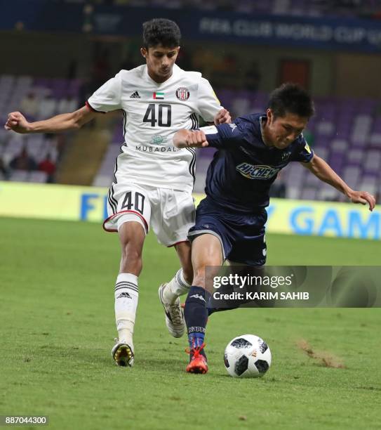 Auckland City's Takuya Iwata fights for the ball against UAE's Al-Jazira club player Mohamad al-Attas during their FIFA Club World Cup UAE 2017 first...