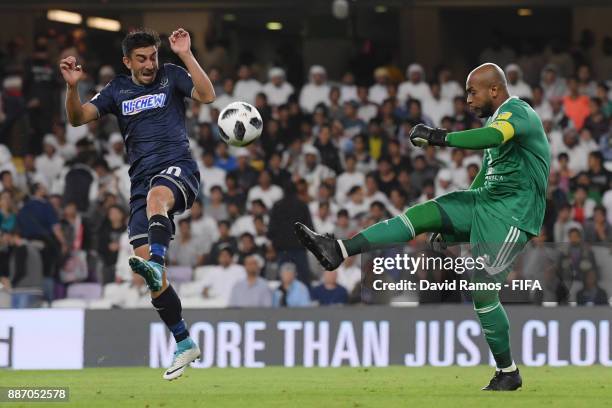 Ali Khaseif of Al-Jazira clears the ball while under pressure from Emiliano Tade of Auckland City FC during the FIFA Club World Cup UAE 2017 play off...