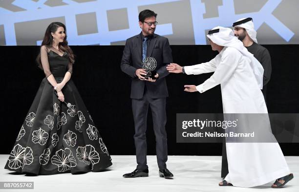 Irrfan Khan on stage receives his Honorary Award from HH Sheikh Mansoor bin Mohammed bin Rashid Al Maktoum and DIFF Chairman Abdulhamid Juma during...