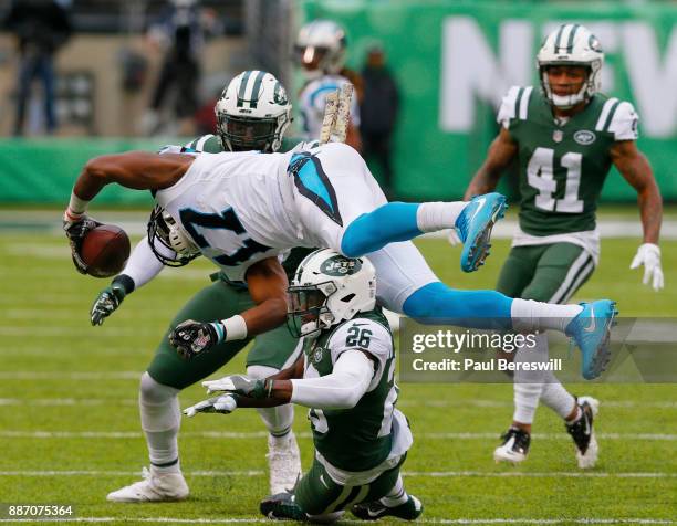 Receiver Devin Funchess of the Carolina Panthers is upended by Marcus Maye of the New York Jets after making a reception and run in an NFL football...