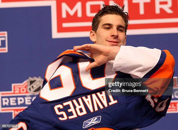 John Tavares puts on his teams jersey after being picked number one overall in the 2009 NHL Entry Draft by the New York Islander at the Bell Centre...