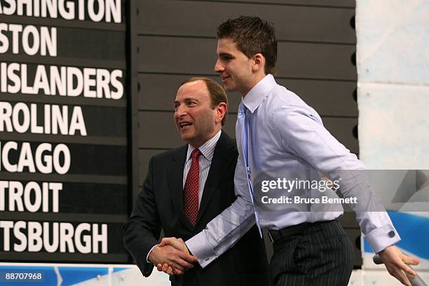 Comissioner Gary Bettman escourts first round pick John Tavares on to the stage after Tavares was picked number one overall in the 2009 NHL Entry...