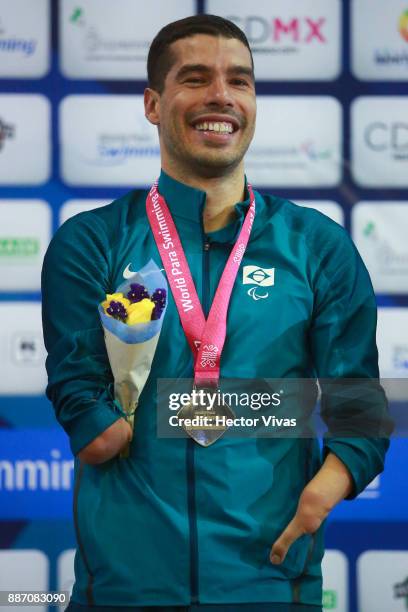 Daniel Dias of Brazil smiles with his gold medal in Men's 50 m Backstroke S5 during day 3 of the Para Swimming World Championship Mexico City 2017 at...