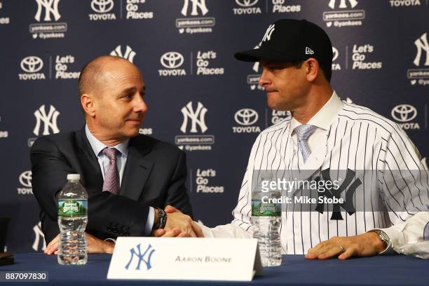 Senior Vice President, General Manager Brian Cashman shakes New York Yankee manager Aaron Boone hand at Yankee Stadium on December 6, 2017 in the...