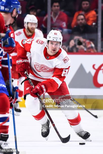 Xavier Ouellet of the Detroit Red Wings skates the puck against the Montreal Canadiens during the NHL game at the Bell Centre on December 2, 2017 in...