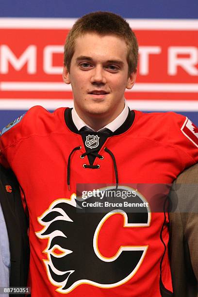 Tim Erixon of the Calgary Flames smiles on stage after he was selected overall by the Flames during the first round of the 2009 NHL Entry Draft at...