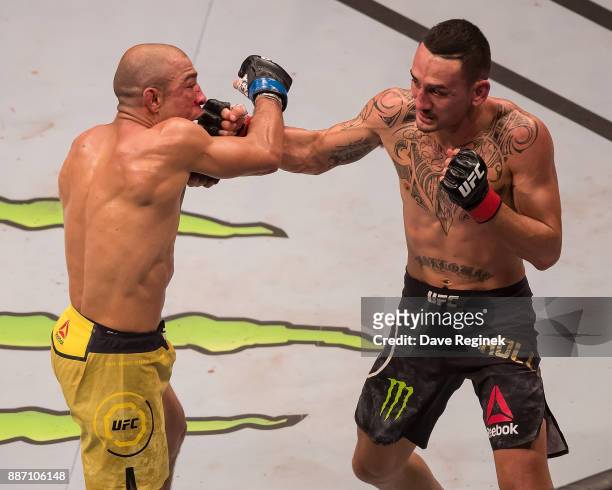 Jose Aldo fights Max Holloway during a UFC bout at Little Caesars Arena on December 2, 2017 in Detroit, Michigan. Holloway defeated Aldo with a TKO...