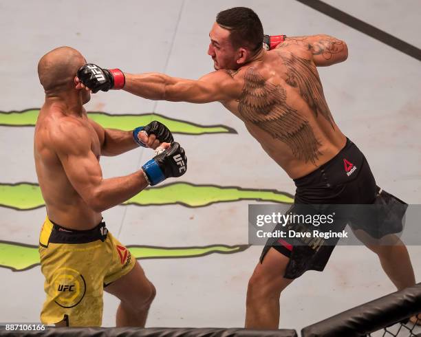 Jose Aldo fights Max Holloway during a UFC bout at Little Caesars Arena on December 2, 2017 in Detroit, Michigan. Holloway defeated Aldo with a TKO...