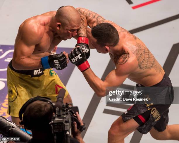 Jose Aldo fights Max Holloway during a UFC bout at Little Caesars Arena on December 2, 2017 in Detroit, Michigan. Holloway defeated Aldo with a TKO...