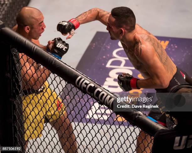 Jose Aldo fights Max Holloway during a UFC bout at Little Caesars Arena on December 2, 2017 in Detroit, Michigan. Holloway defeated Aldo with a TKO...