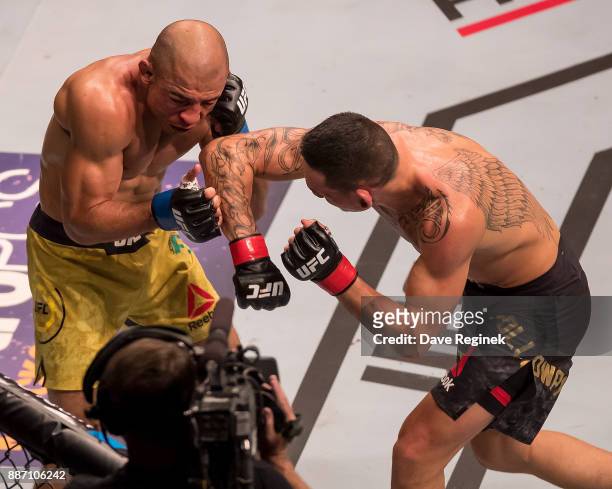 Jose Aldo fights Max Holloway during a UFC bout at Little Caesars Arena on December 2, 2017 in Detroit, Michigan. Holloway defeated Aldo with a TKO...