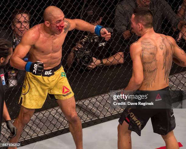 Jose Aldo fights Max Holloway during a UFC bout at Little Caesars Arena on December 2, 2017 in Detroit, Michigan. Holloway defeated Aldo with a TKO...