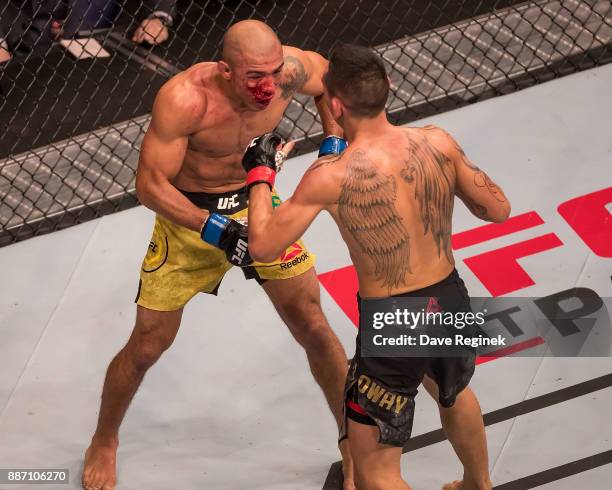 Jose Aldo fights Max Holloway during a UFC bout at Little Caesars Arena on December 2, 2017 in Detroit, Michigan. Holloway defeated Aldo with a TKO...