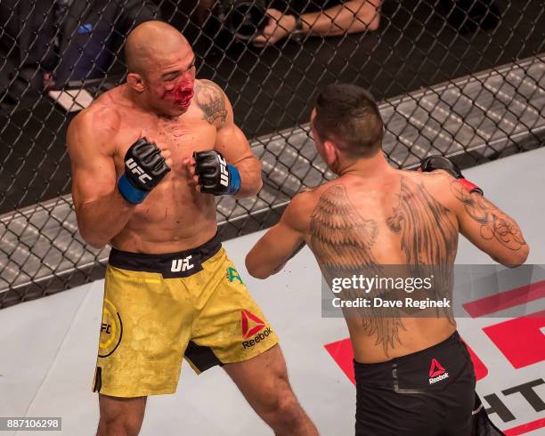 Jose Aldo fights Max Holloway during a UFC bout at Little Caesars Arena on December 2, 2017 in Detroit, Michigan. Holloway defeated Aldo with a TKO...