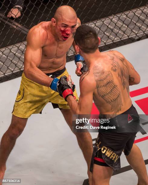 Jose Aldo fights Max Holloway during a UFC bout at Little Caesars Arena on December 2, 2017 in Detroit, Michigan. Holloway defeated Aldo with a TKO...