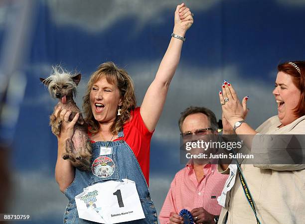 Dawn Goehring of Gatlinburg, Tennesse, reacts with her dog Miss Ellie, a Chinese Crested, after winning the pedigree division of the 21st Annual...