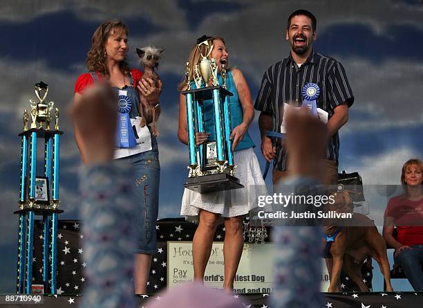 Dawn Goehring and Karen Halligan look on as Miles Egstad of Citrus Heights, California, reacts with his dog Pabst, a boxer mix, after winning the...