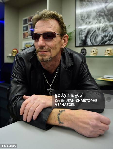 Pascal Grun, local councillor and Johnny Hallyday fan and look alike, poses showing a tattoo on his arm reading "Jamais Seul", the name of one of...