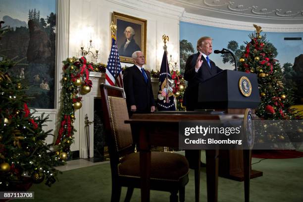President Donald Trump speaks while making a statement on Jerusalem as U.S. Vice President Mike Pence, left, listens in the Diplomatic Room of the...