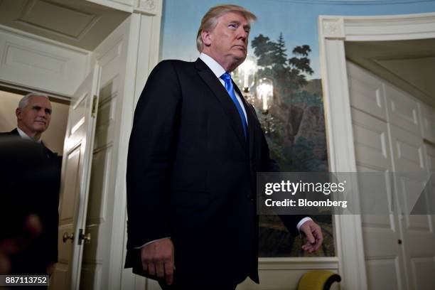 President Donald Trump arrives with U.S. Vice President Mike Pence, left, to make a statement on Jerusalem in the Diplomatic Room of the White House...