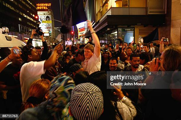 Fans of Michael Jackson dance to his hit song "Beat It" after paying their respects near his star on the Walk of Fame on June 26 a day after his...