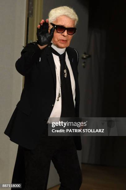 German fashion designer Karl Lagerfeld walks on stage after models presented creations for Chanel during the "Chanel defilee" fashion show at the...