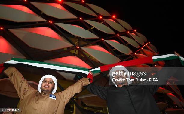 Fans pose for photographs prior to the FIFA Club World Cup UAE 2017 match between Al Jazira and Auckland City FC at Hazza bin Zayed Stadium on...