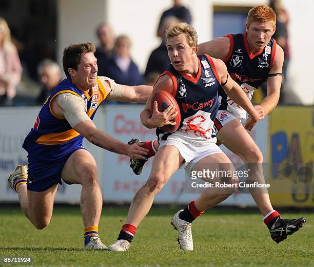 Clint Bartram of the Scorpions breaks away from his opponent during the round 11 VFL match between Williamstown Seagulls and the Casey Scorpions at...