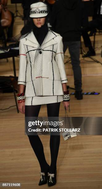 Model presents a creation the "Chanel Metiers d'Art" fashion show at the Elbphilarmonie in Hamburg, nothern Germany, on December 6, 2017.