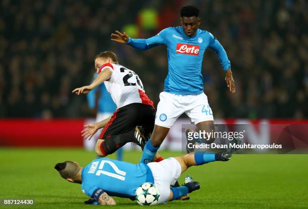 Jens Toornstra of Feyenoord challenges for the ball with Marek Hamsik of SSC Napoli and Amadou Diawara of SSC Napoli during the UEFA Champions League...