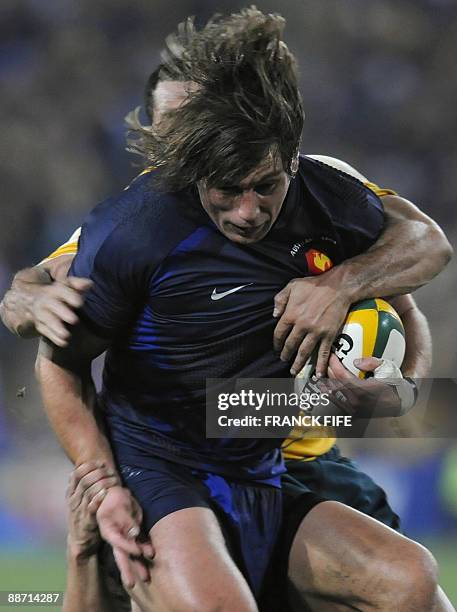 French hooker Dimitri Szarzewski succumbs to a tackle from an Australian player during their rugby union test match on June 27, 2009 at the ANZ...