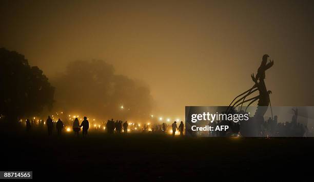 Revellers gather near the Stone Circle in the early hours of the second day of the annual Glastonbury festival near Glastonbury, Somerset on June 27,...