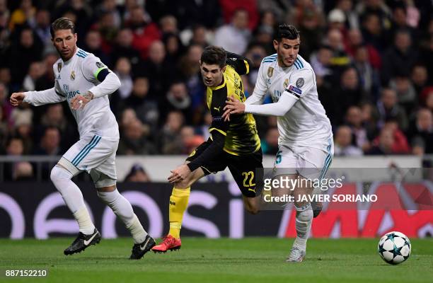 Dortmund's US midfielder Christian Pulisic vies with Real Madrid's Spanish defender Sergio Ramos and Real Madrid's French defender Theo Hernandez...