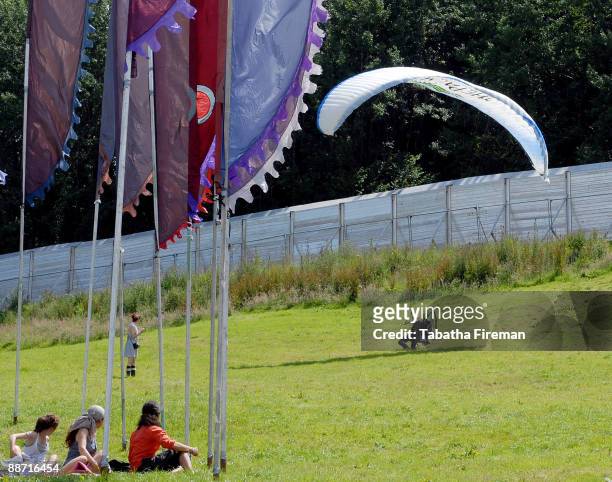 Man, pressumably without a ticket, flies into Worthy Farm on a paraglider during day three of the Glastonbury Festival on June 27, 2009 in...