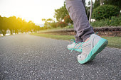 Road to success,running on road with sports shoes,healthy lifestyle sports woman running, female legs with sneakers jogging in evening prepare for marathon