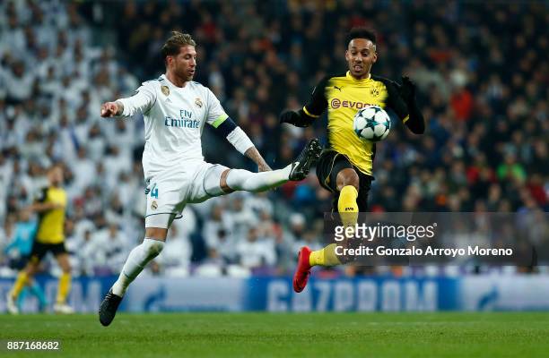 Pierre-Emerick Aubameyang of Borussia Dortmund is challenged by Sergio Ramos of Real Madrid during the UEFA Champions League group H match between...