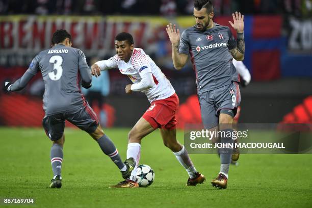 Besiktas' Brazilian defender Adriano Correia, Leipzig's Brazilian defender Bernardo and Besiktas' Spanish forward Alvaro Negredo vie for the ball...