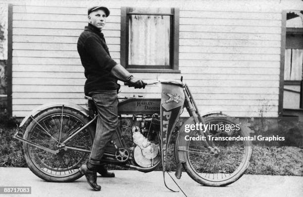 Pittsburgh Pirate fan decorates his early Harley Davidson motorcycle with a pennant proclaiming his allegiance to the team, 1910.