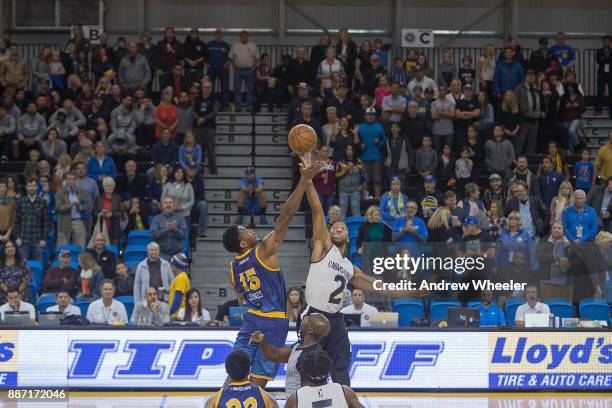 Damian Jones of the Santa Cruz Warriors goes up for the opening tip off against Akil Mitchell the Long Island Nets during an NBA G-League game on...