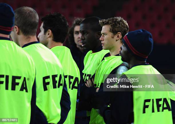 Jonathan Spector of USA listens intently to coach Bob Bradley prior to a training session at Ellis Park on June 27, 2009 in Johannesburg, South...