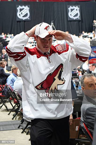 Jordan Szwarz of the Phoenix Coyotes adjusts his hat after he was drafted by the Coyotes in the fourth round during the 2009 NHL Entry Draft at the...