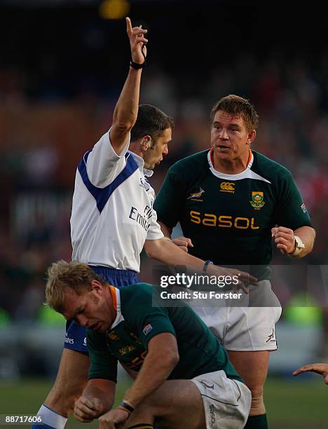 Referee Christophe Berdos makes a decision as John Smit appeals and Schalk Burger looks on during the Second Test match between the South Africa and...